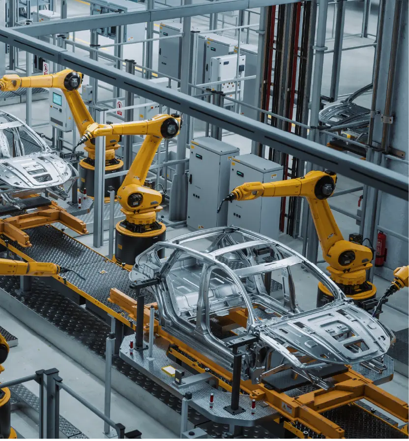 Robotic arms assembling car body frames on an automated production line inside a modern automotive facility