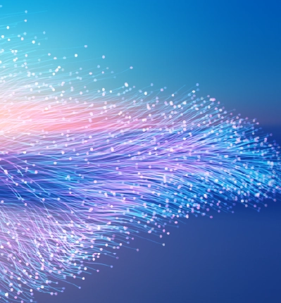 Colorful flowing fiber optic lines with glowing dots representing data flow network connectivity and digital technology